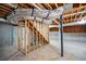 Basement with exposed beams, concrete floor, and unfinished walls, showing potential for customization at 9691 Squirrel Wood Run, Douglasville, GA 30135