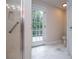Light and airy bathroom with glass shower door and exterior access to yard at 9691 Squirrel Wood Run, Douglasville, GA 30135