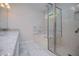 Bathroom with double vanity, marble floors, soaker tub, and a glass-enclosed shower at 9691 Squirrel Wood Run, Douglasville, GA 30135
