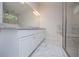Modern bathroom featuring marble floors, granite countertops, and glass enclosed shower at 9691 Squirrel Wood Run, Douglasville, GA 30135
