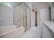 Bathroom featuring double vanity, marble floors, soaker tub, and a glass shower stall at 9691 Squirrel Wood Run, Douglasville, GA 30135
