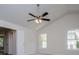Bedroom with neutral walls, two windows providing natural light, and a ceiling fan at 9691 Squirrel Wood Run, Douglasville, GA 30135