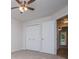 Bright bedroom with a view, featuring neutral carpeting and an open doorway at 9691 Squirrel Wood Run, Douglasville, GA 30135