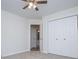 Well-lit bedroom with neutral carpeting, closet, and access to ensuite bathroom at 9691 Squirrel Wood Run, Douglasville, GA 30135