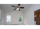 Bedroom featuring neutral walls, carpet, two windows and view into bathroom at 9691 Squirrel Wood Run, Douglasville, GA 30135