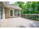 Wooden deck offers an outdoor retreat with views of the green yard and a screened-in porch area at 9691 Squirrel Wood Run, Douglasville, GA 30135