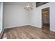 Open dining area with wood look floors and modern light fixture at 9691 Squirrel Wood Run, Douglasville, GA 30135