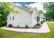 View of the home showcasing painted brick and vinyl siding plus a paved side entrance and lush lawn at 9691 Squirrel Wood Run, Douglasville, GA 30135