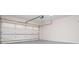 Spacious garage featuring a white garage door, concrete floor, and ample space for parking and storage at 9691 Squirrel Wood Run, Douglasville, GA 30135