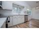 Bright kitchen features white cabinets, granite countertops, and stainless steel appliances at 9691 Squirrel Wood Run, Douglasville, GA 30135