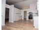 Contemporary kitchen featuring white cabinets, granite countertops, stainless steel appliances, and hardwood floors at 9691 Squirrel Wood Run, Douglasville, GA 30135