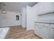 Charming kitchen featuring white cabinets, granite countertops and a view to the backyard at 9691 Squirrel Wood Run, Douglasville, GA 30135