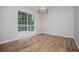 Sunlit living room with wood look floors and sliding glass doors to the deck at 9691 Squirrel Wood Run, Douglasville, GA 30135