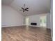 Open living space features hardwood floors, a modern fireplace, and views of the outdoors at 9691 Squirrel Wood Run, Douglasville, GA 30135