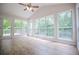 Bright sunroom featuring hardwood floors, large windows, and a door that leads to a deck at 9691 Squirrel Wood Run, Douglasville, GA 30135