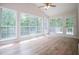 Bright sunroom featuring hardwood floors, large windows, and a ceiling fan for relaxed living at 9691 Squirrel Wood Run, Douglasville, GA 30135
