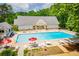 Large community pool surrounded by lounge chairs and tables, perfect for relaxation and social gatherings at 9691 Squirrel Wood Run, Douglasville, GA 30135