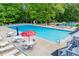 Inviting community pool features ample seating and a 'Lakemont Village' umbrella, creating a relaxing atmosphere at 9691 Squirrel Wood Run, Douglasville, GA 30135