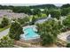 Aerial view showcasing the community pool and clubhouse nestled among lush greenery at 1896 Grove Field Ln # 29, Marietta, GA 30064