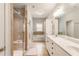 A bright bathroom featuring a walk-in shower, a bathtub, and a vanity with dual sinks at 1896 Grove Field Ln # 29, Marietta, GA 30064