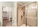 A bright bathroom featuring a walk-in glass shower and an open doorway to the closet at 1896 Grove Field Ln # 29, Marietta, GA 30064