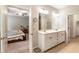 An open main bathroom featuring a double sink vanity, and a view into the main bedroom at 1896 Grove Field Ln # 29, Marietta, GA 30064