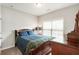 Comfortable bedroom featuring a bed with dark wood frame and a window for natural light at 1896 Grove Field Ln # 29, Marietta, GA 30064