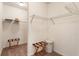 A walk-in closet with shelving and a glimpse into the adjoining bathroom at 1896 Grove Field Ln # 29, Marietta, GA 30064