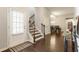 Welcoming home entryway with hardwood floors, staircase, and a view into the dining area at 1896 Grove Field Ln # 29, Marietta, GA 30064