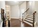 Inviting foyer with hardwood floors, staircase, and a console table at 1896 Grove Field Ln # 29, Marietta, GA 30064