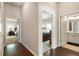 Hallway showing a bedroom, bathroom and bedroom with hardwood floors and neutral paint at 1896 Grove Field Ln # 29, Marietta, GA 30064