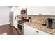 A kitchen boasting granite countertops, stainless steel appliances, and white cabinetry at 1896 Grove Field Ln # 29, Marietta, GA 30064