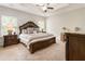 Comfortable bedroom featuring a tray ceiling, carpet flooring, and traditional furnishings at 1896 Grove Field Ln # 29, Marietta, GA 30064