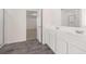 Bright bathroom with double vanity and open doorway to carpeted bedroom at 281 Sandy Oak Dr, Loganville, GA 30052