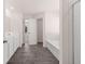 Bathroom featuring gray tile flooring, double vanity, shower, and separate tub at 281 Sandy Oak Dr, Loganville, GA 30052