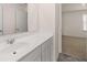 Well-lit bathroom featuring a modern sink and vanity with stone flooring at 281 Sandy Oak Dr, Loganville, GA 30052