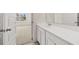 Beautiful bathroom features a pristine white vanity and view of an adjacent room at 281 Sandy Oak Dr, Loganville, GA 30052