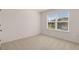 Bedroom with neutral carpet, a window with view, and white walls at 281 Sandy Oak Dr, Loganville, GA 30052