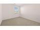Bedroom with neutral carpet, white walls and a window for natural light at 281 Sandy Oak Dr, Loganville, GA 30052