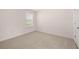 Cozy bedroom with a sunlit window and neutral carpeting at 281 Sandy Oak Dr, Loganville, GA 30052