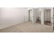 View of bedroom with bathroom and closet entryways, neutral carpet, and white walls at 281 Sandy Oak Dr, Loganville, GA 30052