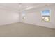 Bright main bedroom features a tray ceiling, plush carpet, and two large windows for natural light at 281 Sandy Oak Dr, Loganville, GA 30052
