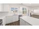 Bright, open kitchen featuring stainless appliances, white countertops, and backyard views at 281 Sandy Oak Dr, Loganville, GA 30052