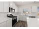 Updated kitchen features new stainless steel appliances and white countertops at 281 Sandy Oak Dr, Loganville, GA 30052