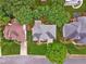 An aerial view of the house with a pergola-covered deck, mature trees, and manicured backyard and lawn at 310 Arbor Creek Trl, Roswell, GA 30076