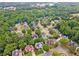 A residential area filled with mature trees surrounds well-maintained homes and manicured lawns at 310 Arbor Creek Trl, Roswell, GA 30076