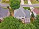 The rear exterior of the house features a pergola-covered deck and is surrounded by mature trees and greenery at 310 Arbor Creek Trl, Roswell, GA 30076