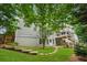 Backyard with a deck, stone path, grass, and multilevel patio at 310 Arbor Creek Trl, Roswell, GA 30076