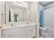 This bright bathroom includes a double sink vanity and tub with a shower at 310 Arbor Creek Trl, Roswell, GA 30076