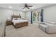 Comfortable bedroom with ceiling fan, large window, and light gray walls at 310 Arbor Creek Trl, Roswell, GA 30076
